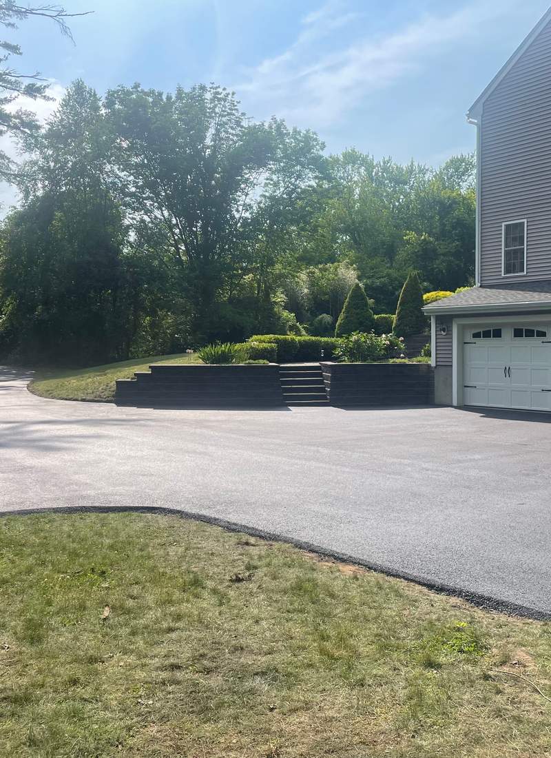New asphalt driveway with curb
